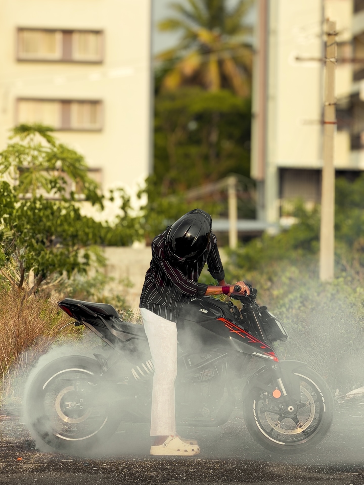 Sachin doing a burnout on his KTM Duke, tyre smoke rising