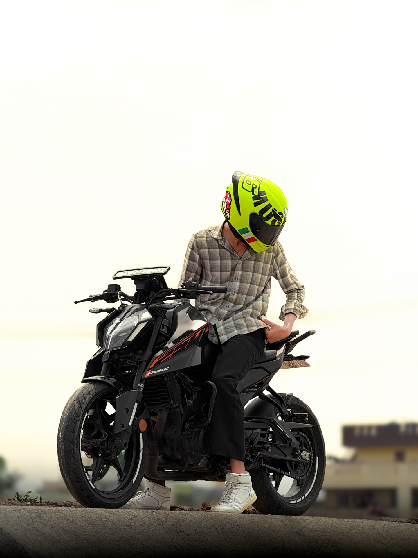 KTM Duke at golden hour, rider in neon helmet